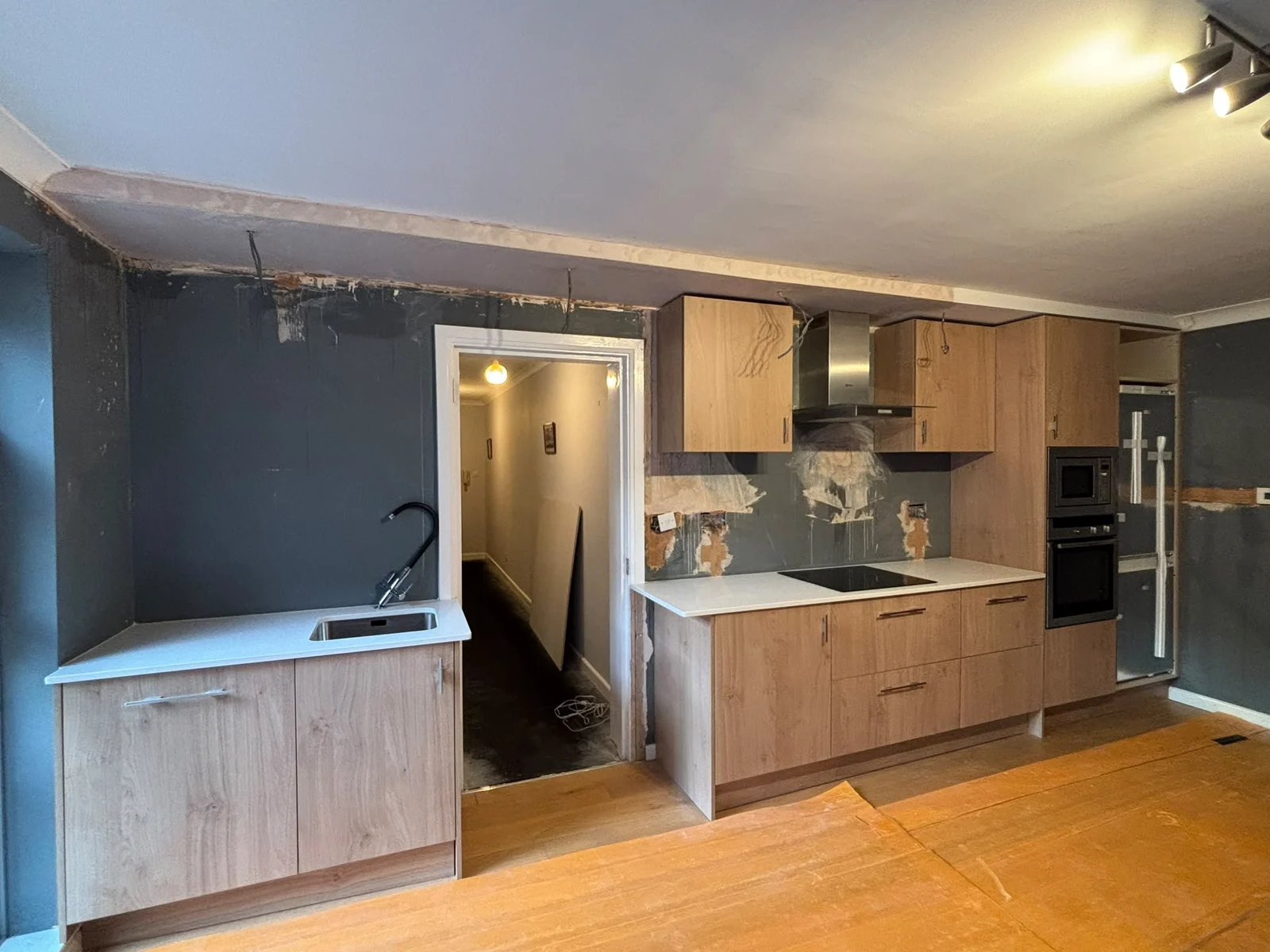 Oak kitchen units and marble-effect splashback during installation — RV Renovation, Oxford