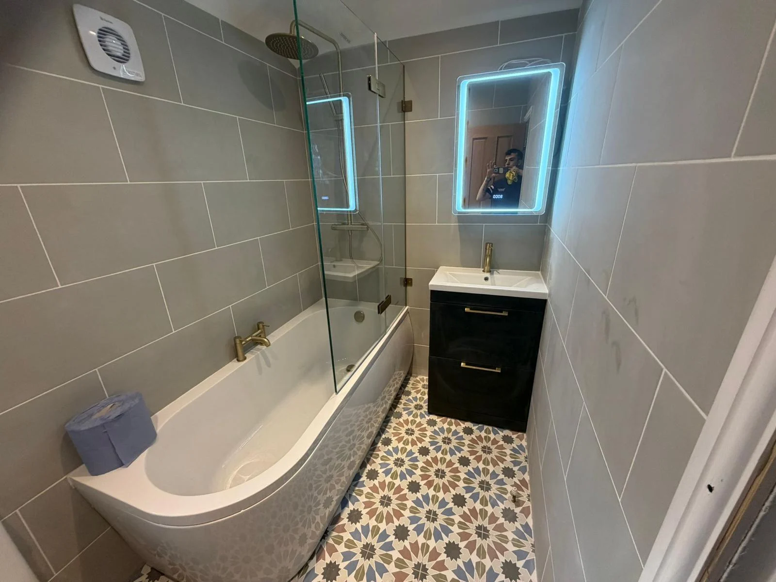 Bath, illuminated mirror and patterned tile floor in a finished bathroom — RV Renovation, Oxford