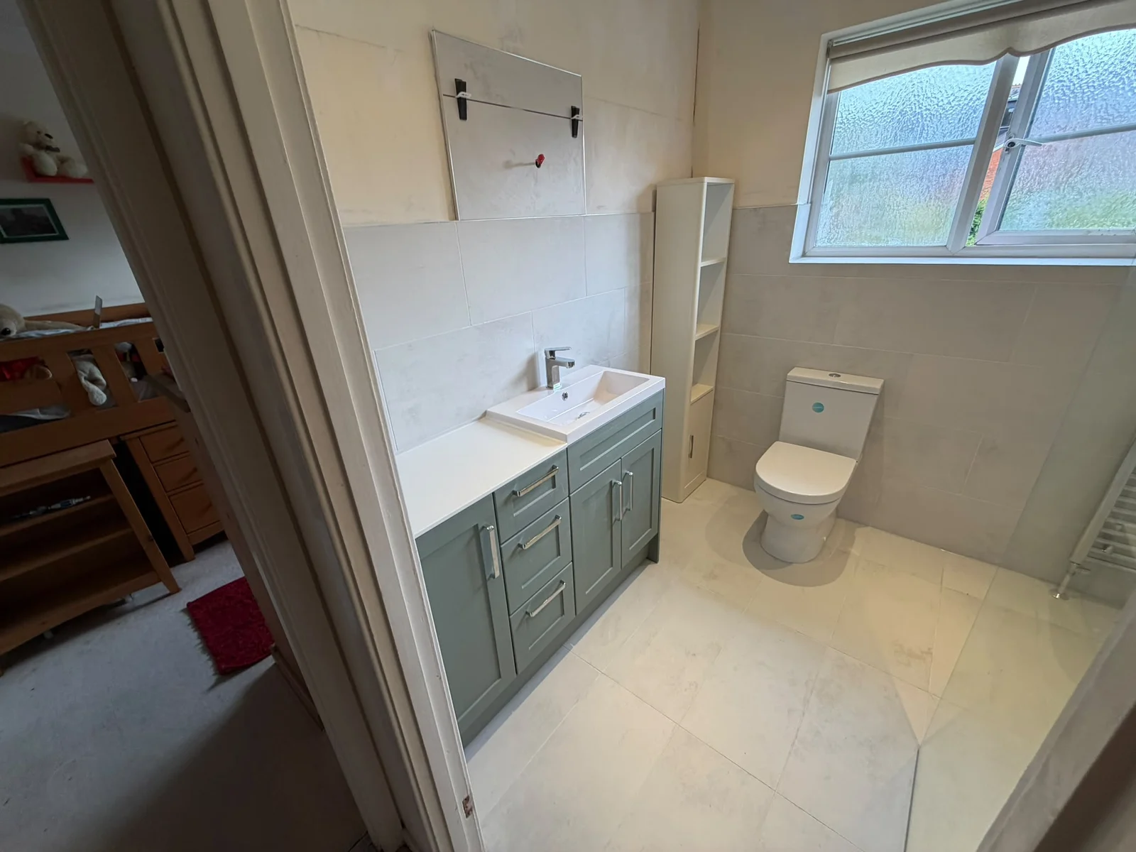 Sage-green vanity with basin and large-format grey tiles — RV Renovation, Oxford