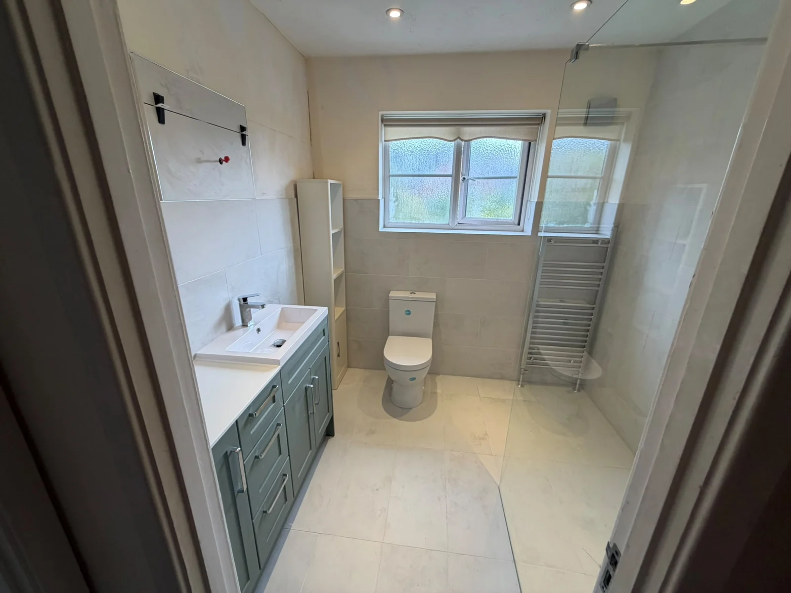 Wet room with green vanity, tiled shower and high window — RV Renovation, Oxford