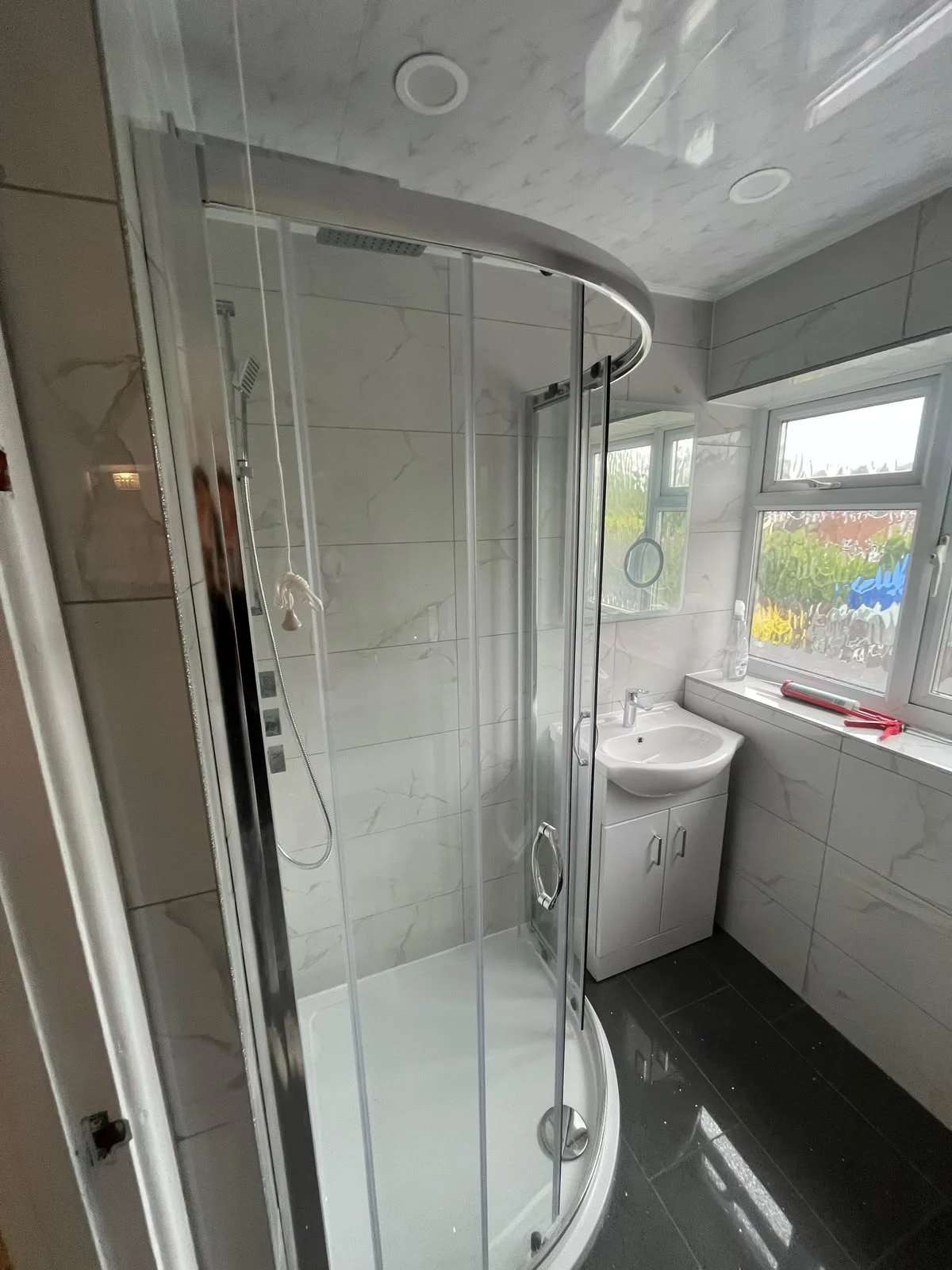 Glass shower enclosure beside the bathroom vanity — RV Renovation, Oxford